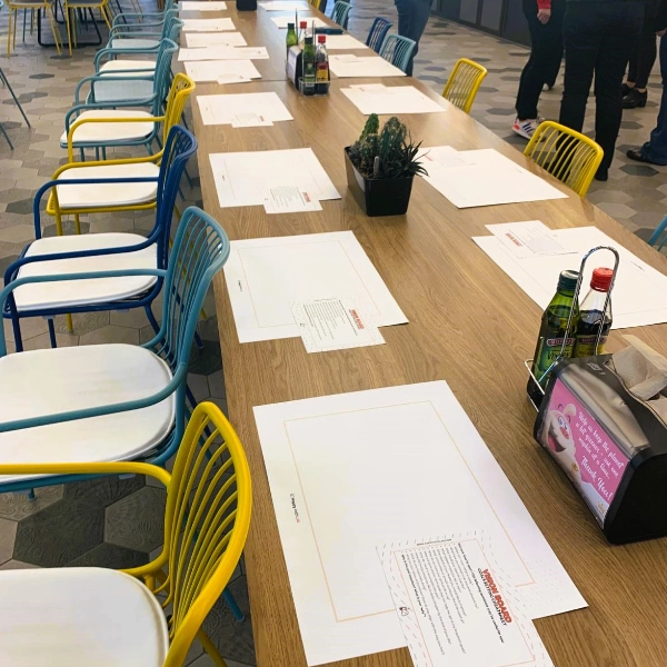 Tables set up with worksheets for a HappyPathLAB team workshop